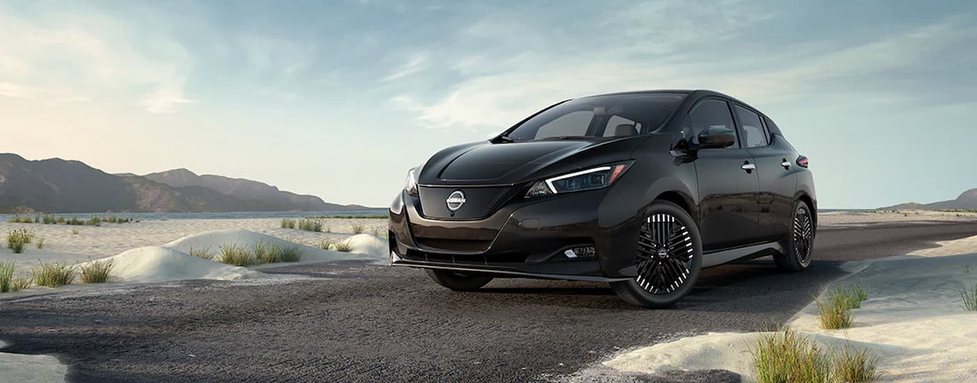 A black 2025 Nissan LEAF SV Plus parked on a road.