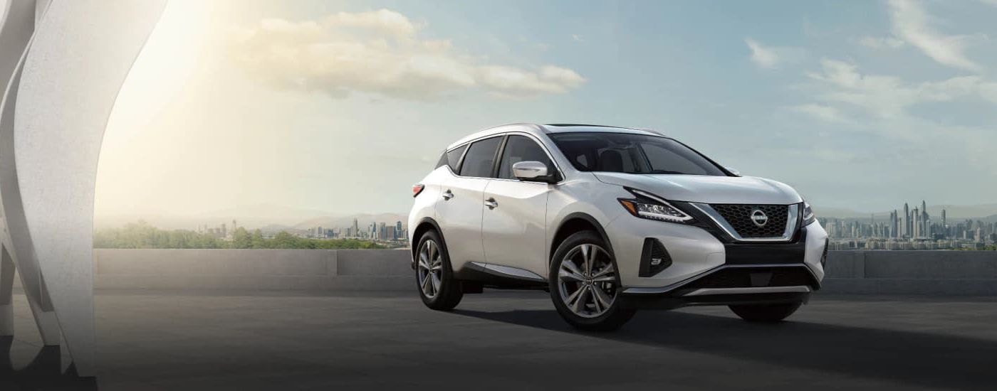 A white 2023 Nissan Murano is shown parked near a city.