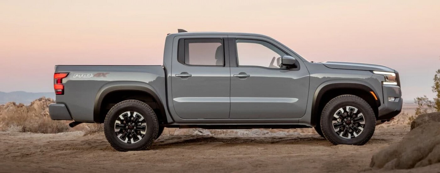 A gray 2022 Nissan Frontier Pro-4X is shown parked off-road.